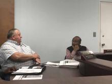 Councilman Hagan, left, explains the proposed details of getting a new sign at Reform City Park as Reform Mayor Harton listens.